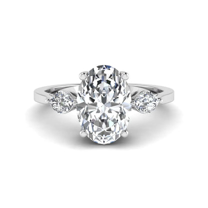 Oval cut lab grown diamond three stone engagement ring with marquise side diamonds in a prong setting featuring a white gold tone design.