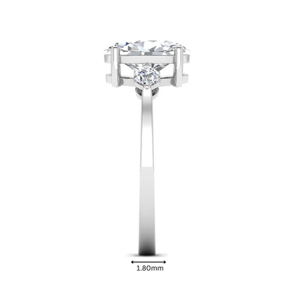 Oval cut lab grown diamond three stone engagement ring with marquise side diamonds in a prong setting featuring a white gold tone design.