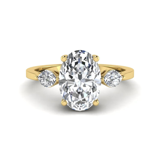 Oval cut lab grown diamond three stone engagement ring with marquise side diamonds in a prong setting featuring a yellow gold tone design.