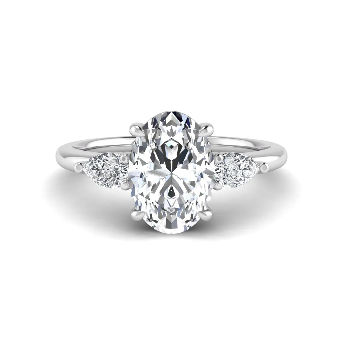 Oval cut lab grown diamond three stone engagement ring with pear side diamonds in a prong setting featuring a white gold tone design.