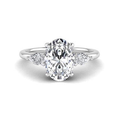 Oval cut lab grown diamond three stone engagement ring with pear side diamonds in a prong setting featuring a white gold tone design.