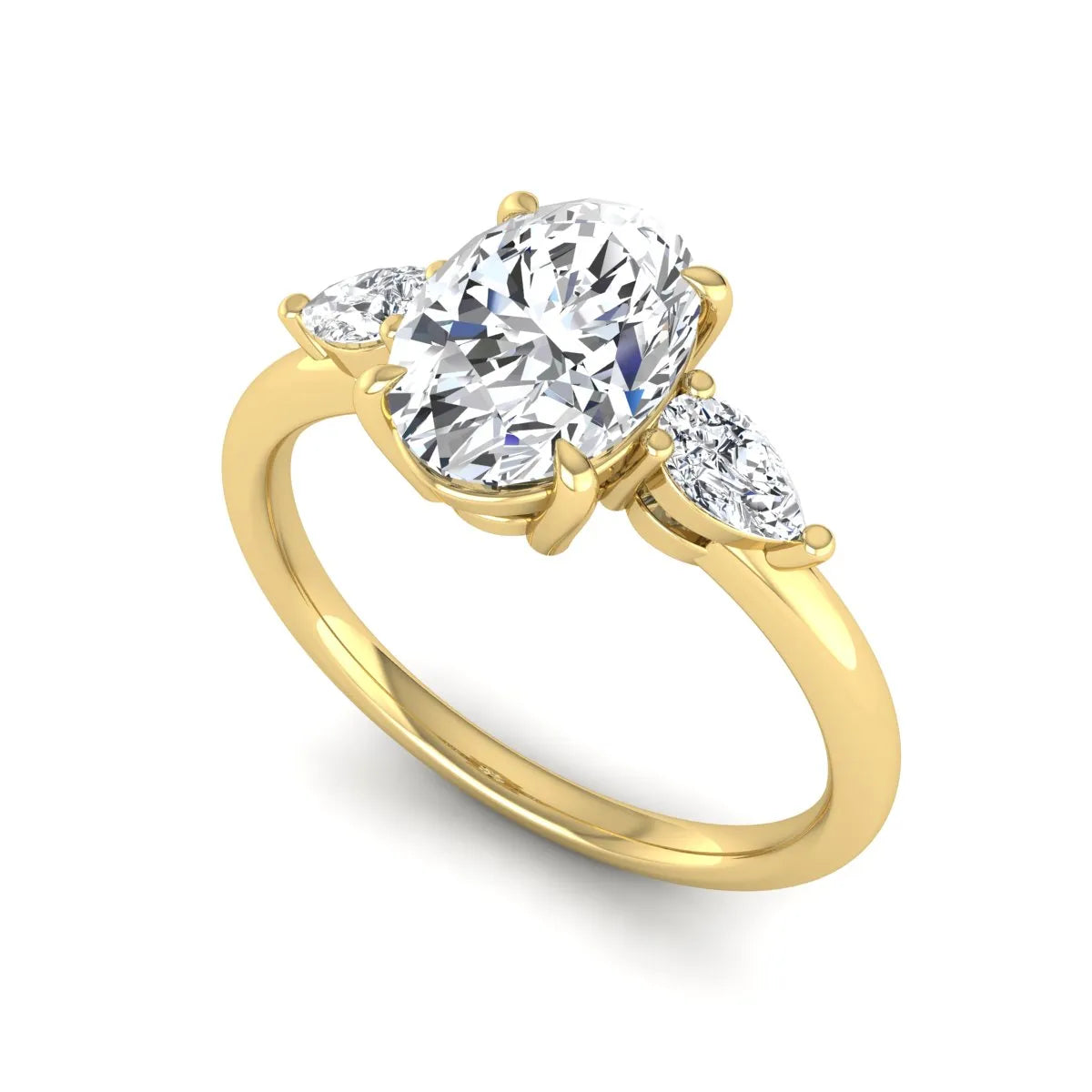 Oval cut lab grown diamond three stone engagement ring with pear side diamonds in a prong setting featuring a yellow gold tone design.
