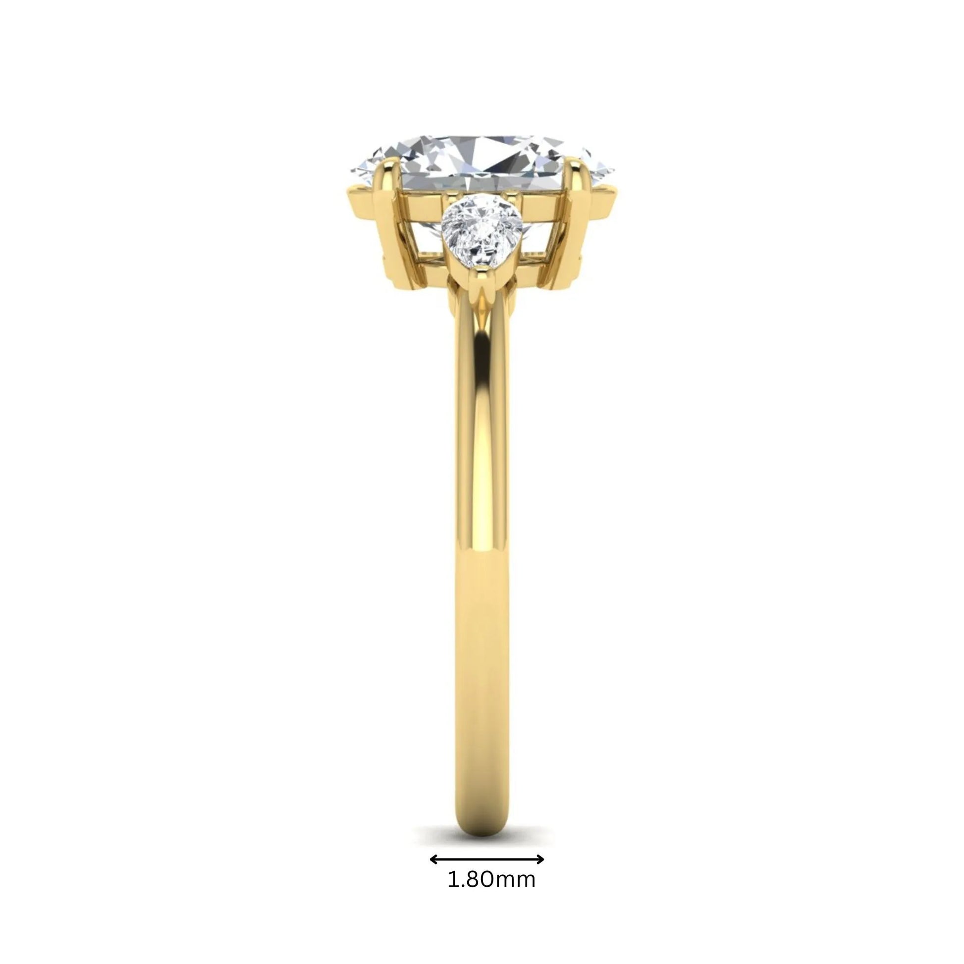 Oval cut lab grown diamond three stone engagement ring with pear side diamonds in a prong setting featuring a yellow gold tone design.