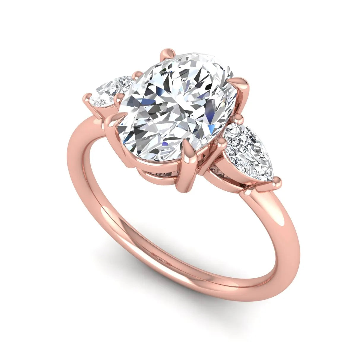 Oval cut lab grown diamond three stone engagement ring with pear cut side diamonds in a prong setting on a polished rose gold band.