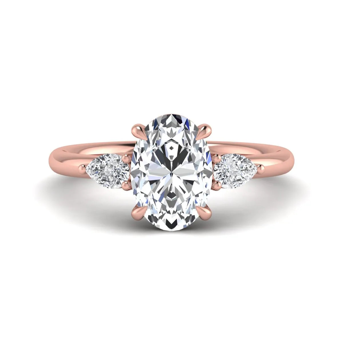 Oval cut lab grown diamond three stone engagement ring with pear cut side diamonds in a prong setting on a polished rose gold band.