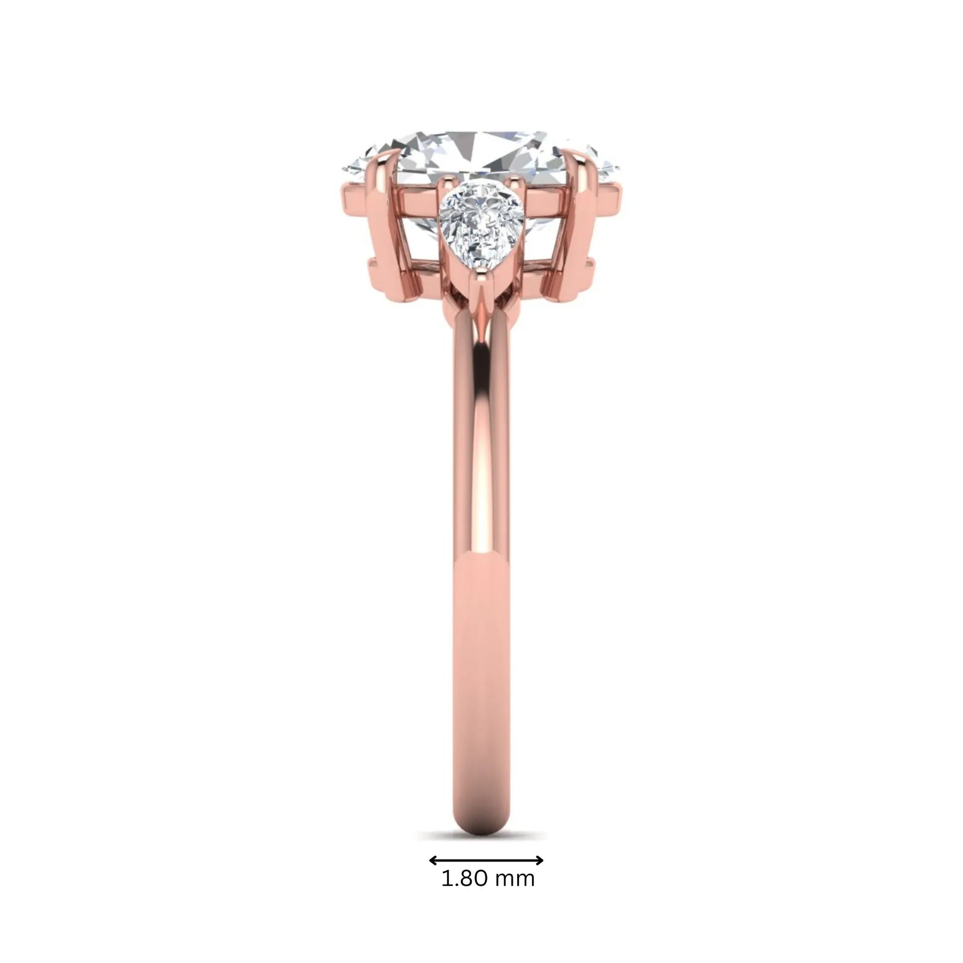 Oval cut lab grown diamond three stone engagement ring with pear cut side diamonds in a prong setting on a polished rose gold band.