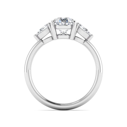 Oval cut lab grown diamond three stone engagement ring with pear cut side diamonds in a prong setting on a polished white gold band.