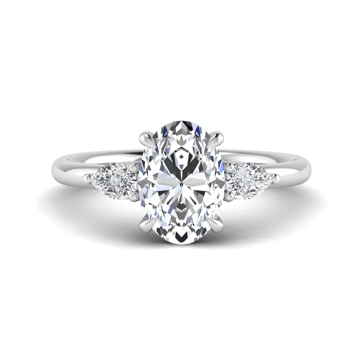 Oval cut lab grown diamond three stone engagement ring with pear cut side diamonds in a prong setting on a polished white gold band.