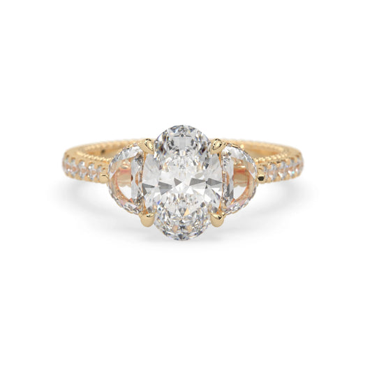 Oval three stone pavé lab grown diamond engagement ring with round and half moon side diamonds in yellow gold
