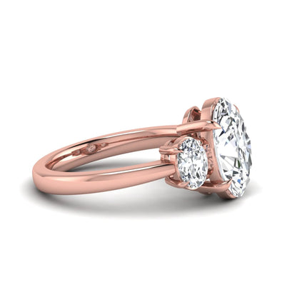 Oval three stone prong set lab grown diamond engagement ring featuring a 3.00 carat oval center diamond with matching oval side diamonds in rose gold finish.