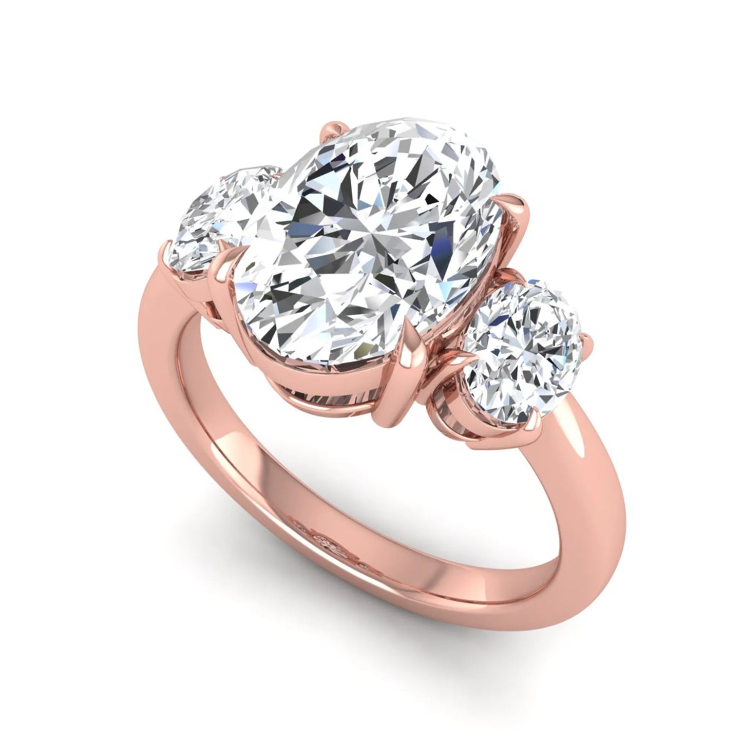 Oval three stone prong set lab grown diamond engagement ring featuring a 3.00 carat oval center diamond with matching oval side diamonds in rose gold finish.