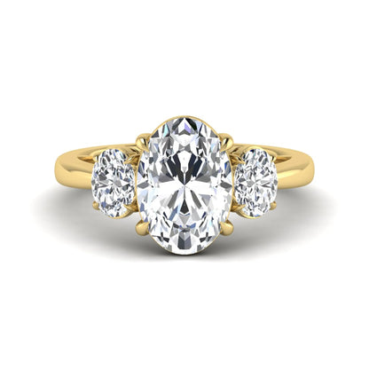Oval three stone prong set lab grown diamond engagement ring featuring a 3.00 carat oval center diamond with matching oval side diamonds in yellow gold finish.