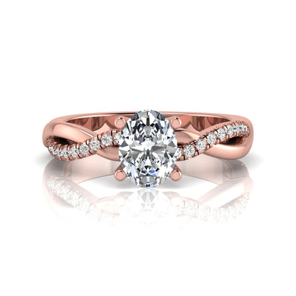 Oval cut lab grown diamond engagement ring featuring a 1.21 carat center diamond in a four-prong setting with a twisted pavé accent band and polished rose gold finish.