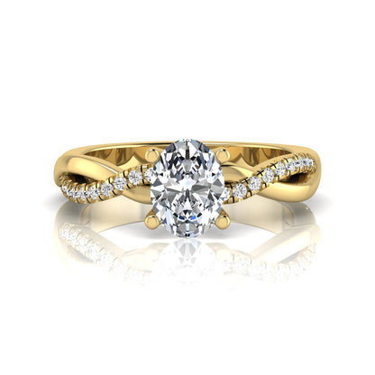 Oval cut lab grown diamond engagement ring featuring a 1.21 carat center diamond in a four-prong setting with a twisted pavé accent band and polished yellow gold finish.