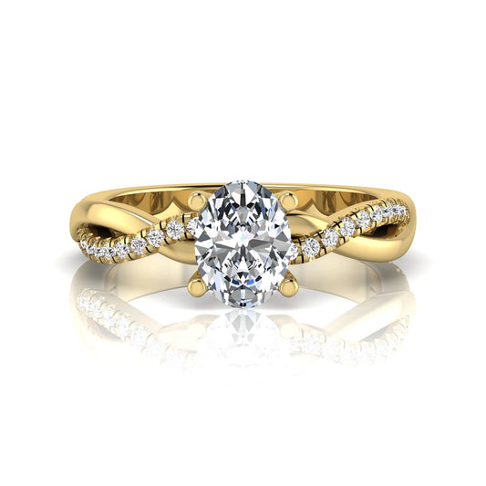 Oval cut lab grown diamond engagement ring featuring a 1.21 carat center diamond in a four-prong setting with a twisted pavé accent band and polished yellow gold finish.