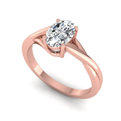 Oval twisted shank solitaire lab grown diamond engagement ring featuring a 1.50 carat IGI certified oval cut diamond in a rose gold setting.