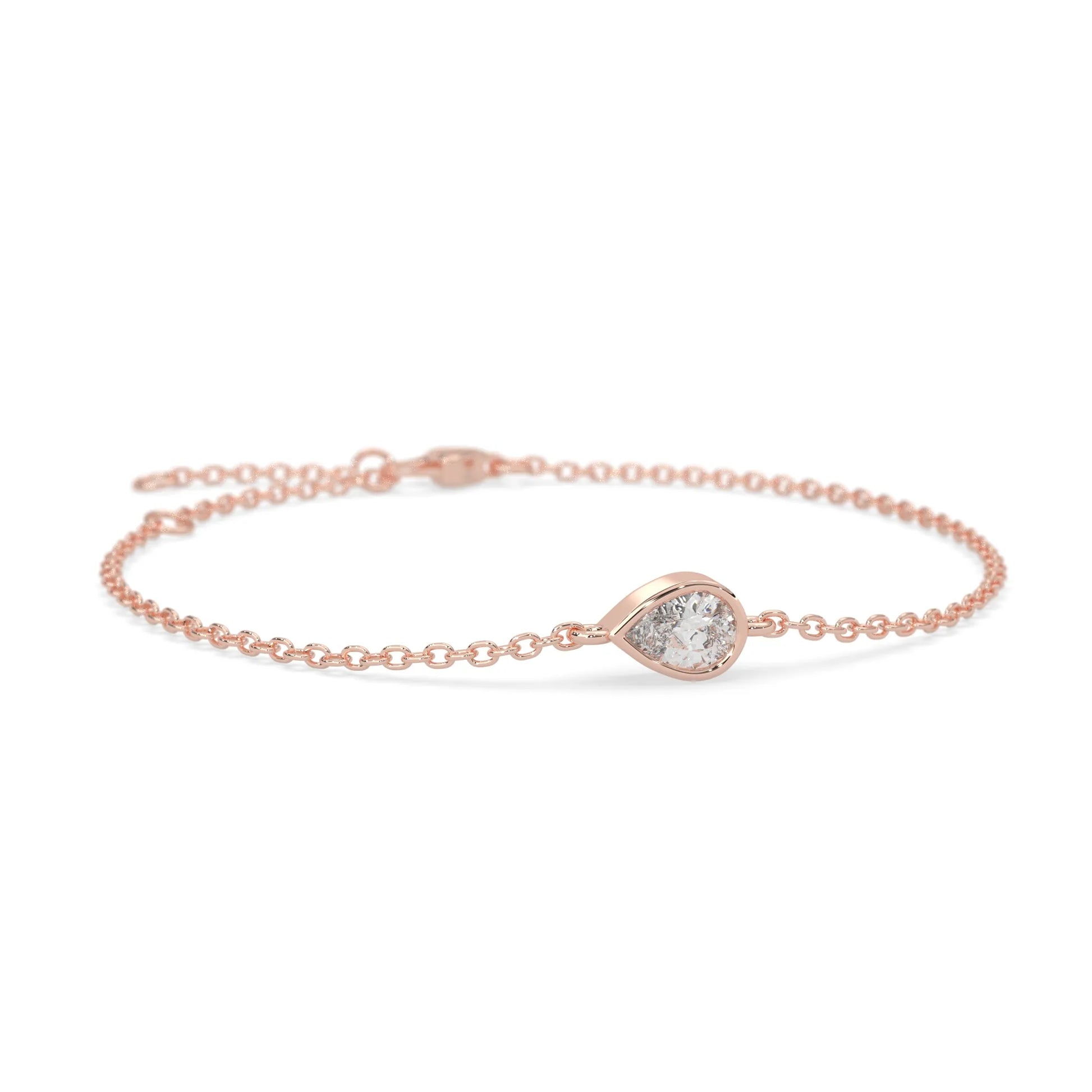 Pear cut lab grown diamond bezel set solitaire bracelet with delicate chain and lobster clasp in rose gold tone.