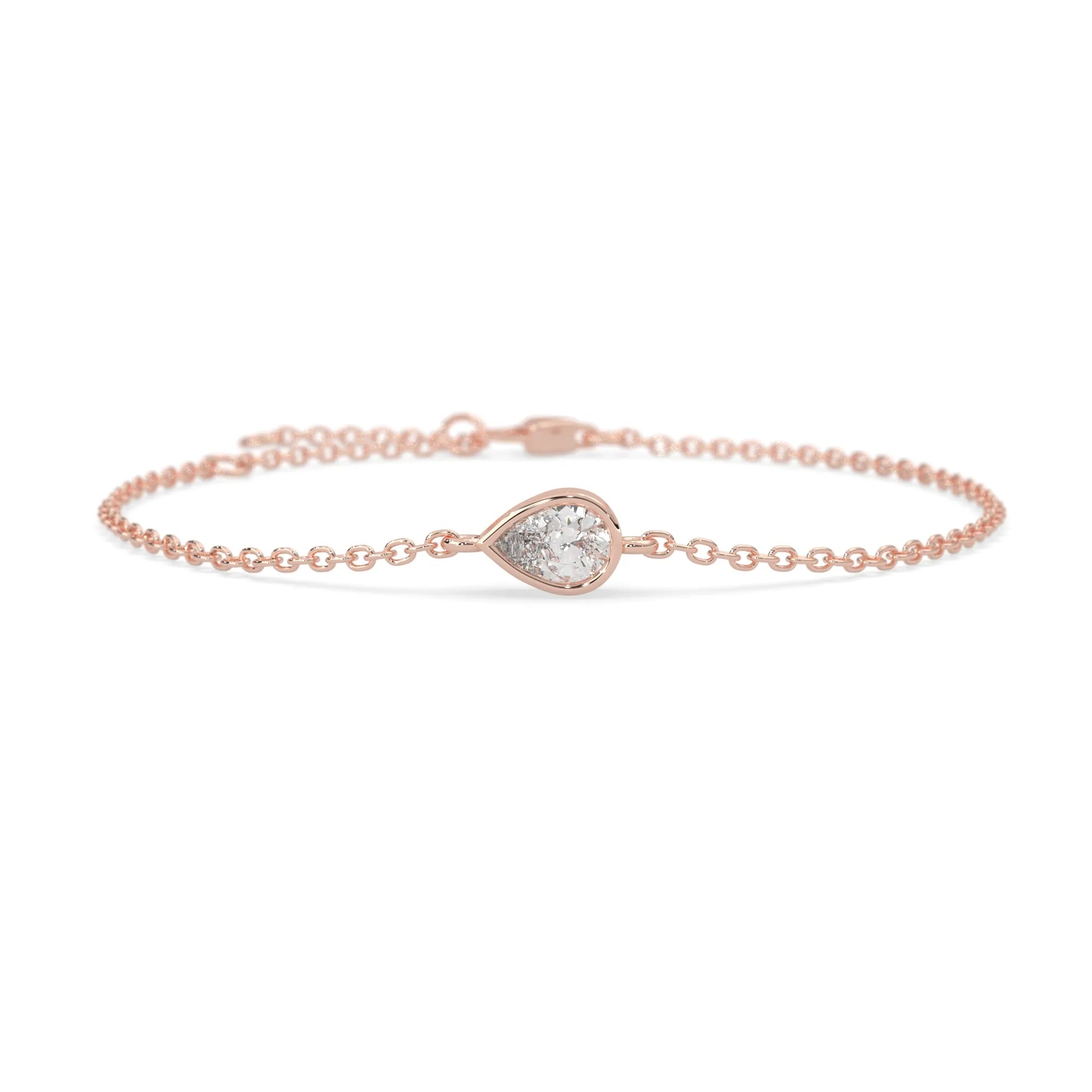 Pear cut lab grown diamond bezel set solitaire bracelet with delicate chain and lobster clasp in rose gold tone.