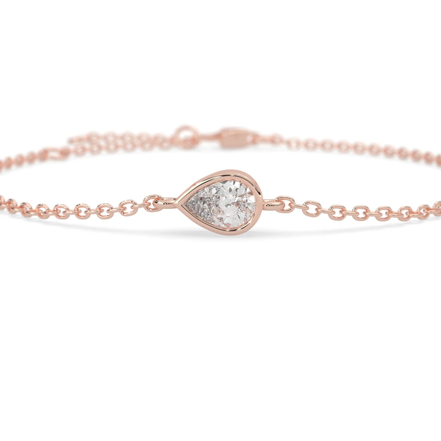 Pear cut lab grown diamond bezel set solitaire bracelet with delicate chain and lobster clasp in rose gold tone.