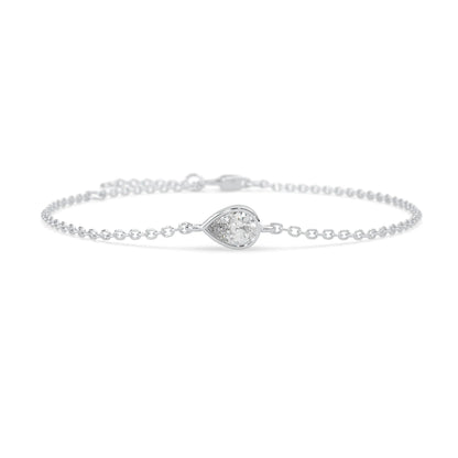 Pear cut lab grown diamond bezel set solitaire bracelet with delicate chain and lobster clasp in white gold tone.