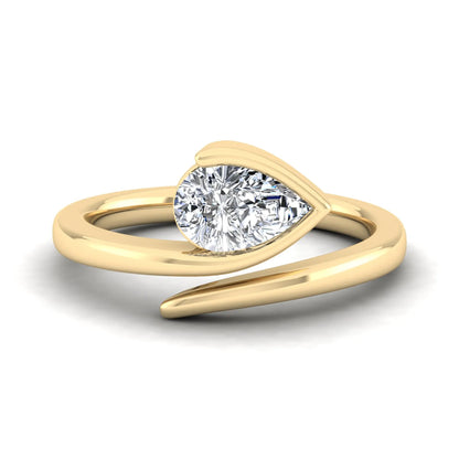 Pear cut lab grown diamond bypass engagement ring featuring a 1.00 carat IGI certified diamond in a modern partial bezel setting with a yellow gold design.