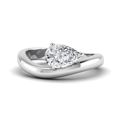 Pear cut lab grown diamond curved solitaire engagement ring with a four-prong setting in white gold