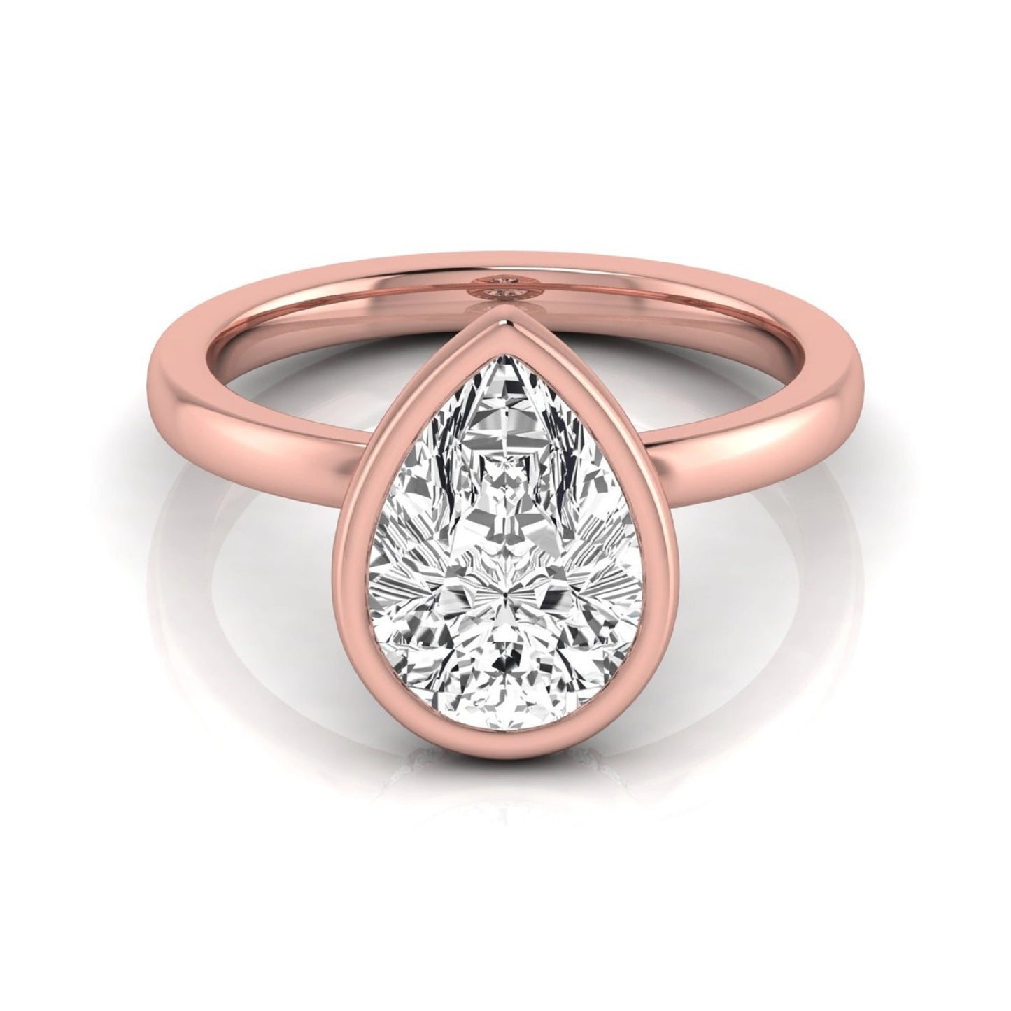 Pear cut lab grown diamond engagement ring featuring a 1.80 carat IGI certified diamond in a bezel setting with a hidden halo of round diamonds on a rose gold band.