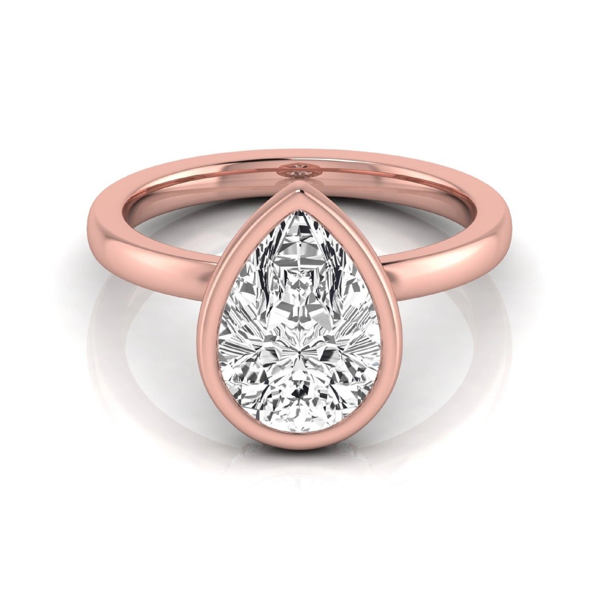 Pear cut lab grown diamond engagement ring featuring a 1.80 carat IGI certified diamond in a bezel setting with a hidden halo of round diamonds on a rose gold band.