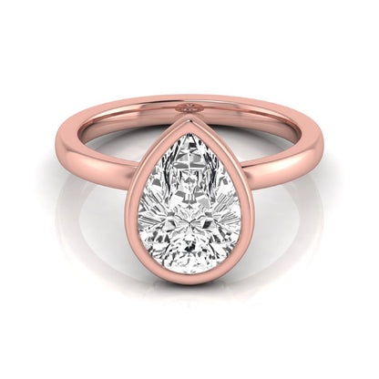 Pear cut lab grown diamond engagement ring featuring a 1.80 carat IGI certified diamond in a bezel setting with a hidden halo of round diamonds on a rose gold band.