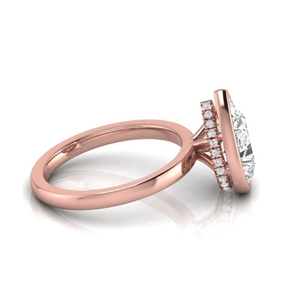 Pear cut lab grown diamond engagement ring featuring a 1.80 carat IGI certified diamond in a bezel setting with a hidden halo of round diamonds on a rose gold band.