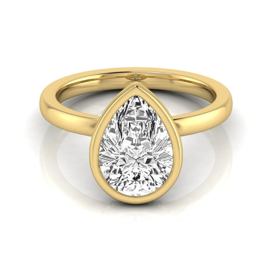 Pear cut lab grown diamond engagement ring featuring a 1.80 carat IGI certified diamond in a bezel setting with a hidden halo of round diamonds on a yellow gold band.