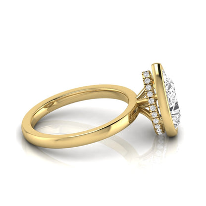 Pear cut lab grown diamond engagement ring featuring a 1.80 carat IGI certified diamond in a bezel setting with a hidden halo of round diamonds on a yellow gold band.