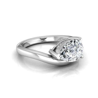Pear cut lab grown diamond curved solitaire engagement ring in white gold with a sculpted curved band and IGI certified center diamond.