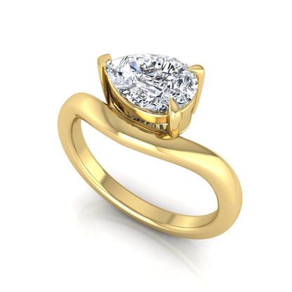 Pear cut lab grown diamond curved solitaire engagement ring in yellow gold with a sculpted curved band and IGI certified center diamond.