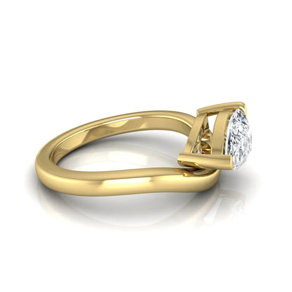 Pear cut lab grown diamond curved solitaire engagement ring in yellow gold with a sculpted curved band and IGI certified center diamond.