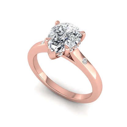 Pear cut lab grown diamond engagement ring with hidden halo and flush set round accent diamonds in rose gold featuring a 1.75 carat IGI certified center diamond.