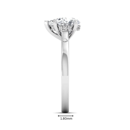 Pear cut lab grown diamond engagement ring with hidden halo and flush set round accent diamonds in white gold featuring a 1.75 carat IGI certified center diamond.