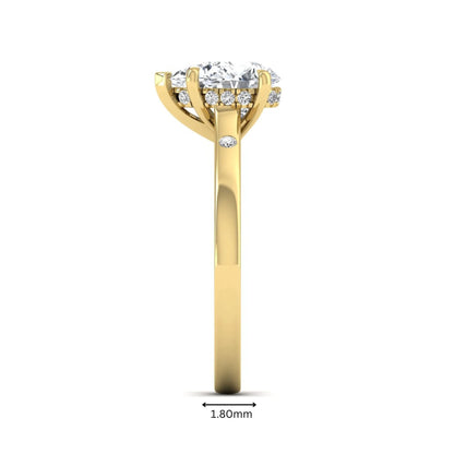 Pear cut lab grown diamond engagement ring with hidden halo and flush set round accent diamonds in yellow gold featuring a 1.75 carat IGI certified center diamond.