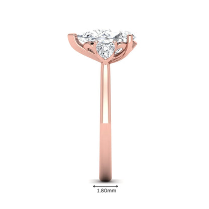 IGI certified pear cut lab grown diamond three stone engagement ring with pear side diamonds in rose gold.