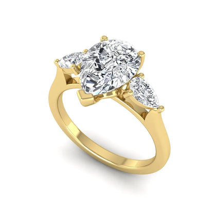 IGI certified pear cut lab grown diamond three stone engagement ring with pear side diamonds in yellow gold.