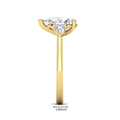IGI certified pear cut lab grown diamond three stone engagement ring with pear side diamonds in yellow gold.