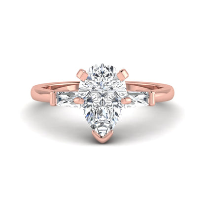 Pear cut lab grown diamond three stone engagement ring featuring a 2.31 carat IGI certified center diamond with tapered baguette side diamonds in rose gold.