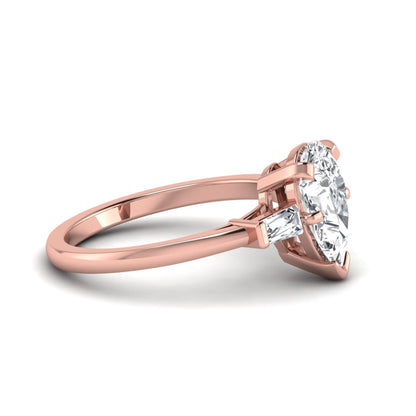 Pear cut lab grown diamond three stone engagement ring featuring a 2.31 carat IGI certified center diamond with tapered baguette side diamonds in rose gold.
