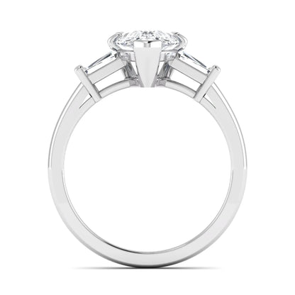 Pear cut lab grown diamond three stone engagement ring featuring a 2.31 carat IGI certified center diamond with tapered baguette side diamonds in white gold.