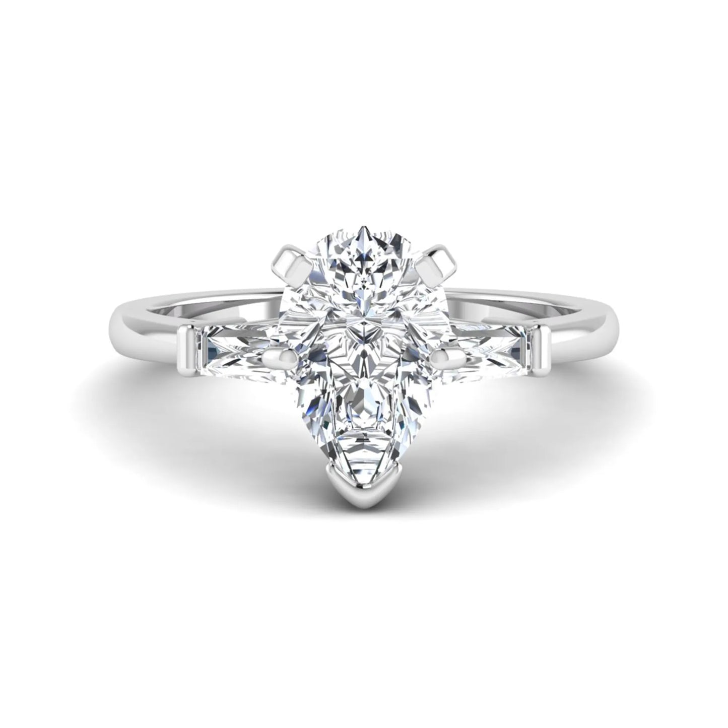 Pear cut lab grown diamond three stone engagement ring featuring a 2.31 carat IGI certified center diamond with tapered baguette side diamonds in white gold.