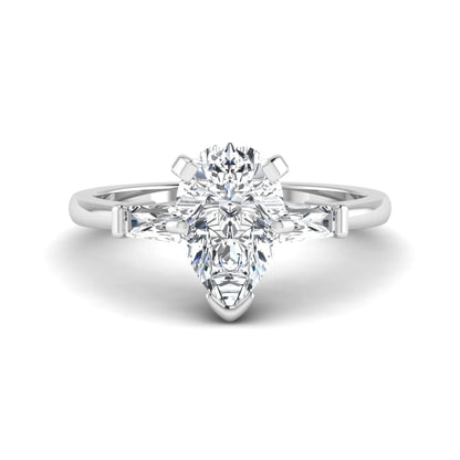 Pear cut lab grown diamond three stone engagement ring featuring a 2.31 carat IGI certified center diamond with tapered baguette side diamonds in white gold.