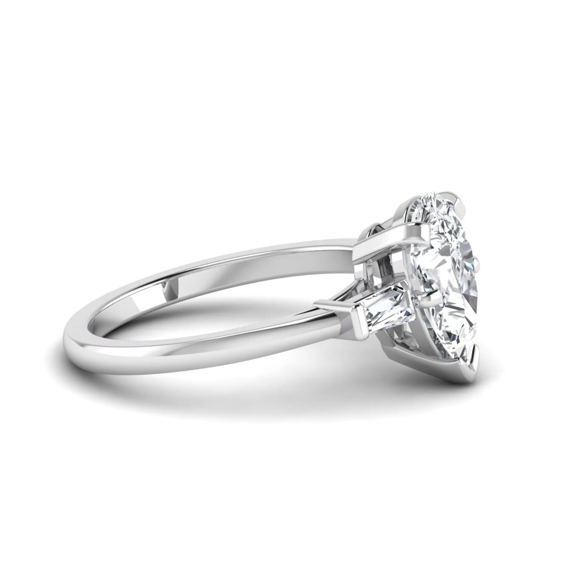 Pear cut lab grown diamond three stone engagement ring featuring a 2.31 carat IGI certified center diamond with tapered baguette side diamonds in white gold.