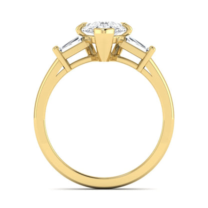 Pear cut lab grown diamond three stone engagement ring featuring a 2.31 carat IGI certified center diamond with tapered baguette side diamonds in yellow gold.