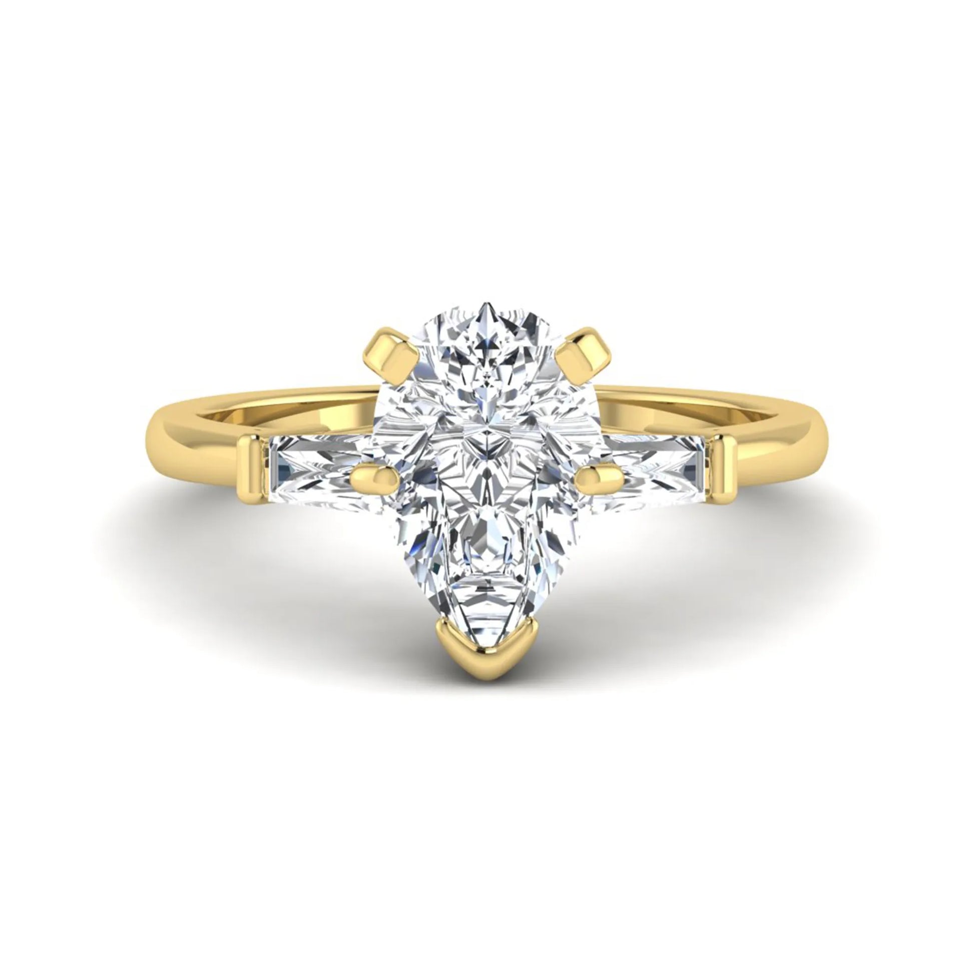 Pear cut lab grown diamond three stone engagement ring featuring a 2.31 carat IGI certified center diamond with tapered baguette side diamonds in yellow gold.
