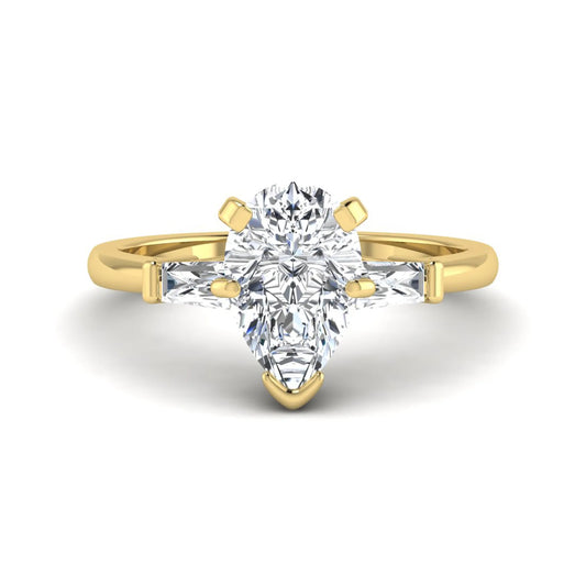Pear cut lab grown diamond three stone engagement ring featuring a 2.31 carat IGI certified center diamond with tapered baguette side diamonds in yellow gold.